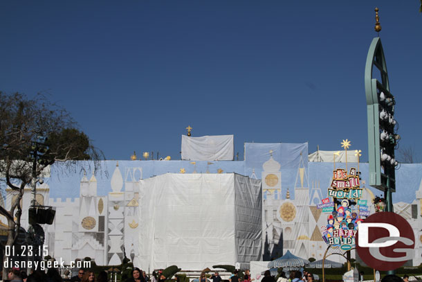 The white tarps now have a photo of the Small World Facade on them and the clock tower is covered.