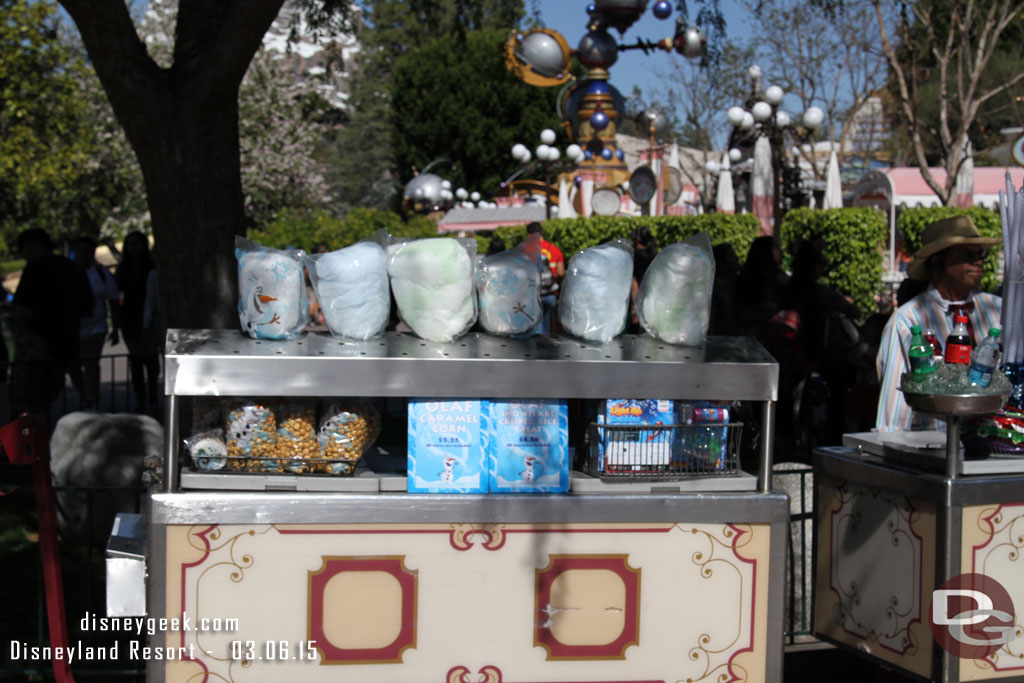 An Outdoor Vending Cart near the Corn Dog wagon/across from the Photo store features an assortment of Olaf Treats.