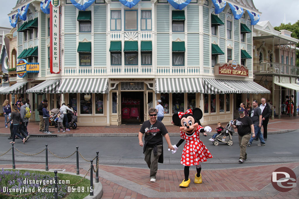 Minnie leading a guest to Town Square.