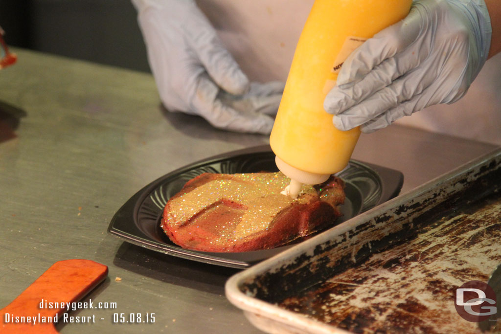 A cast member preparing a waffle cake