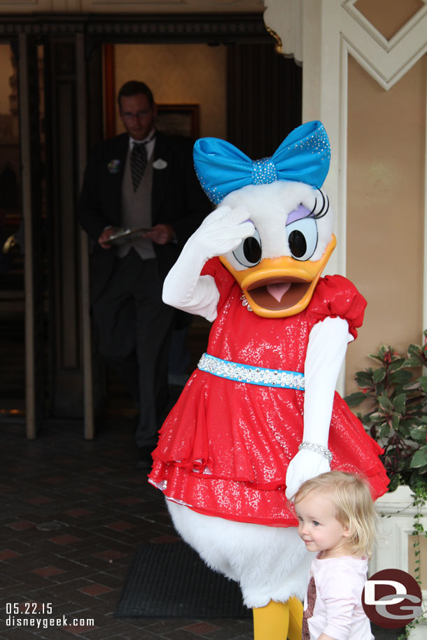 The characters have new costumes for the 60th.  Here is Daisy meeting a young guest.