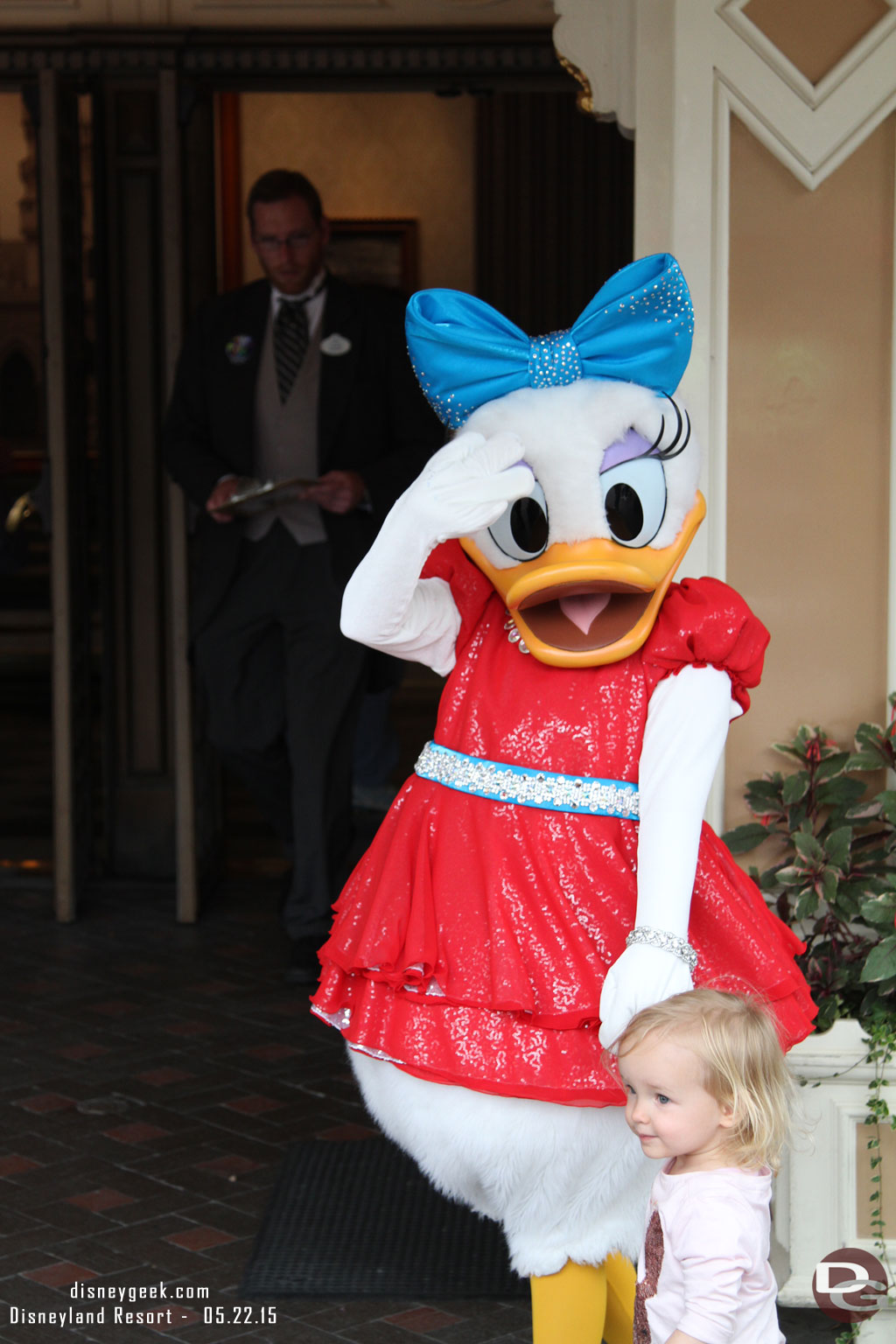 The characters have new costumes for the 60th.  Here is Daisy meeting a young guest.