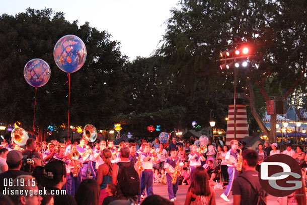 The band moves down the parade route and stops just short of the Fantasyland walkway and performs Let it Go.