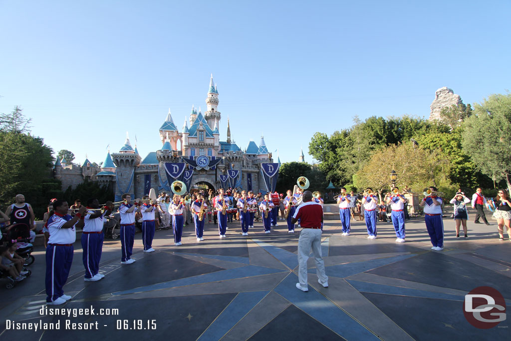 The All-American College Band performing in front of Sleeping Beauty Castle at 6:15pm