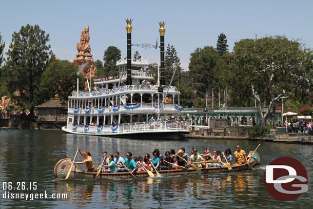 A canoe passing by and the Mark Twain preparing to cast off on the Rivers of America.  