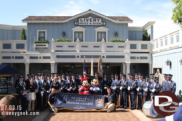 The United States Air Force Honor Guard posing for a picture with Mickey and Minnie before they march in the pre-parade.