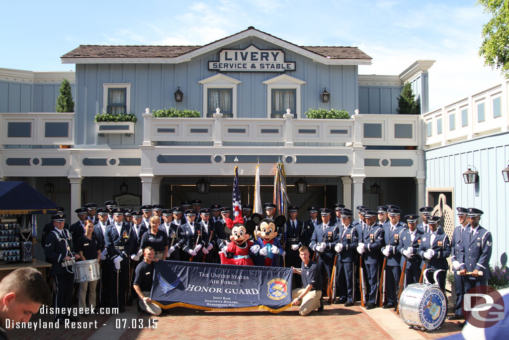 The United States Air Force Honor Guard posing for a picture with Mickey and Minnie before they march in the pre-parade.