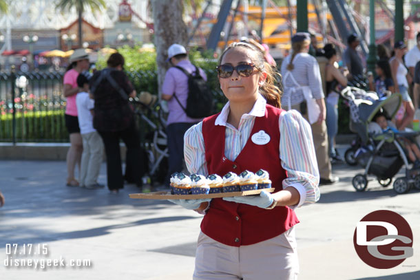 Cast Members walking around Paradise Pier passing out cupcakes to anyone who wanted one.