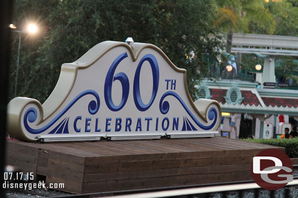 The back of the 60th celebration sign in front of the train station.