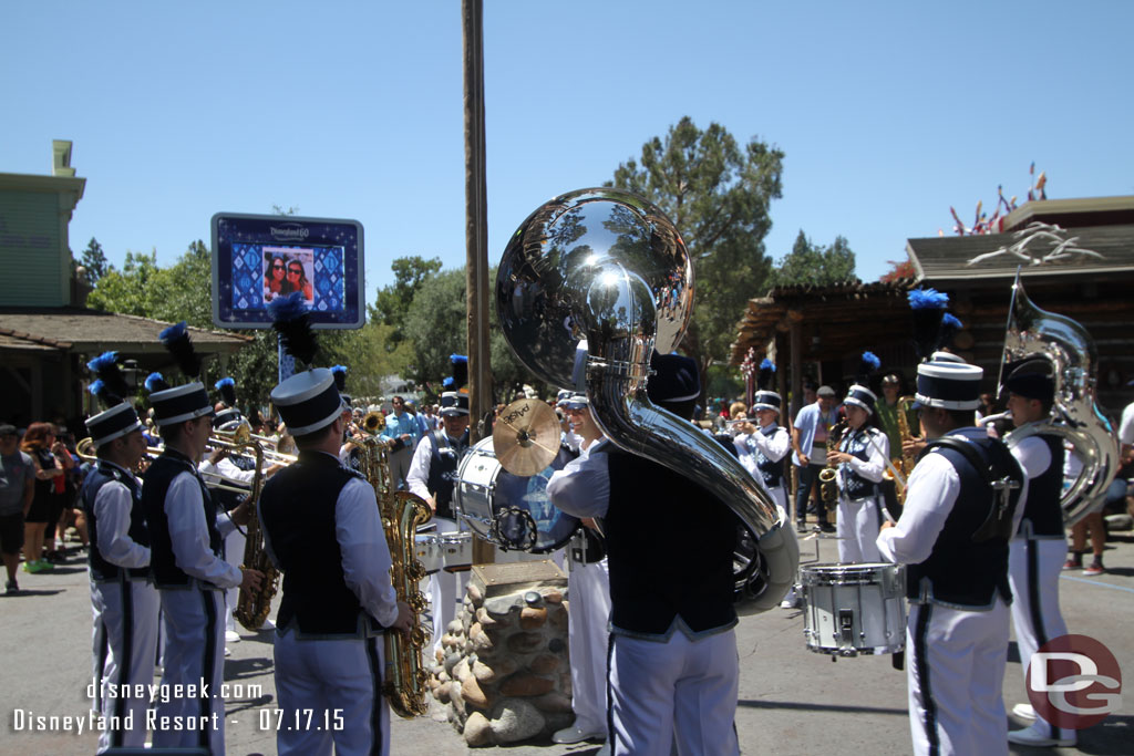 They gather around the Frontierland flag pole to open the set.