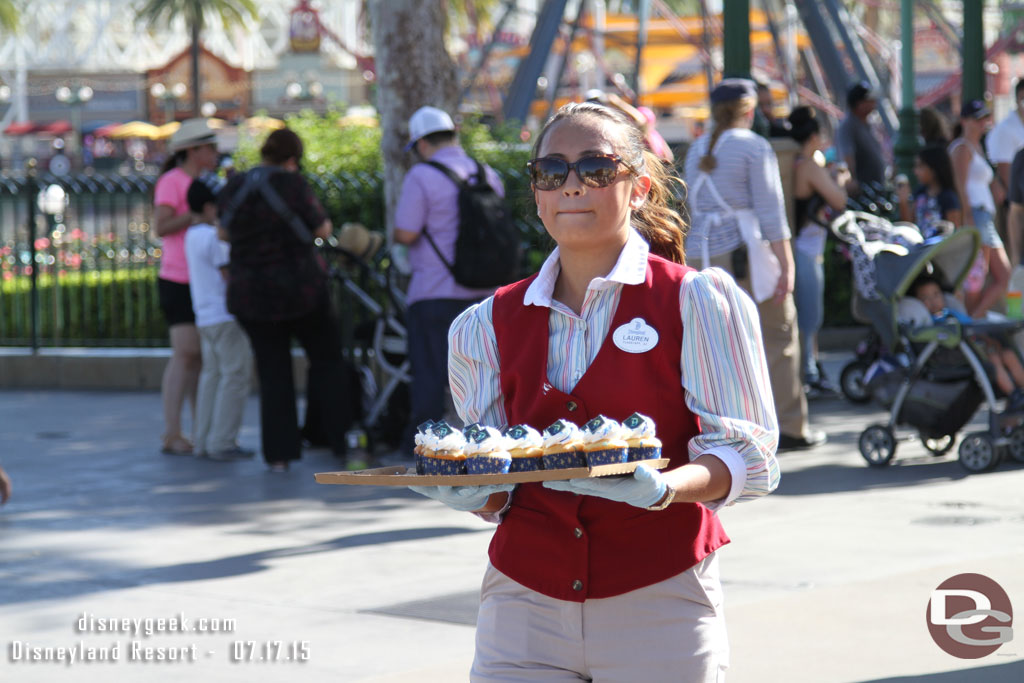 Cast Members walking around Paradise Pier passing out cupcakes to anyone who wanted one.