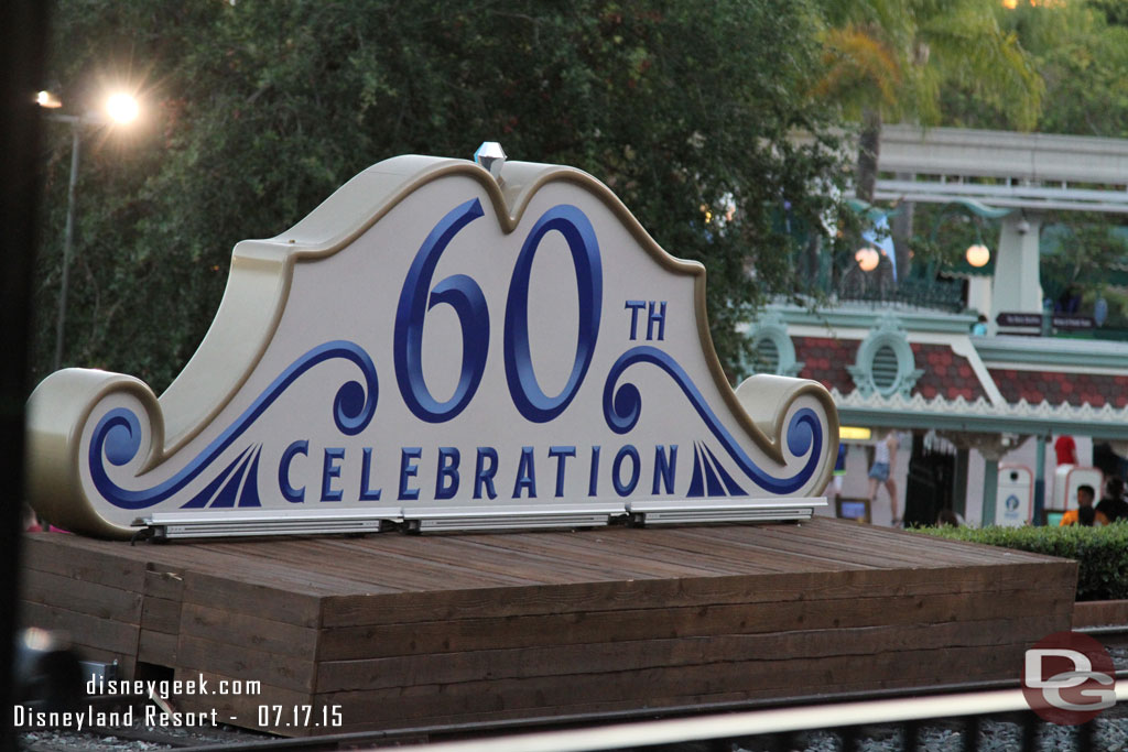 The back of the 60th celebration sign in front of the train station.