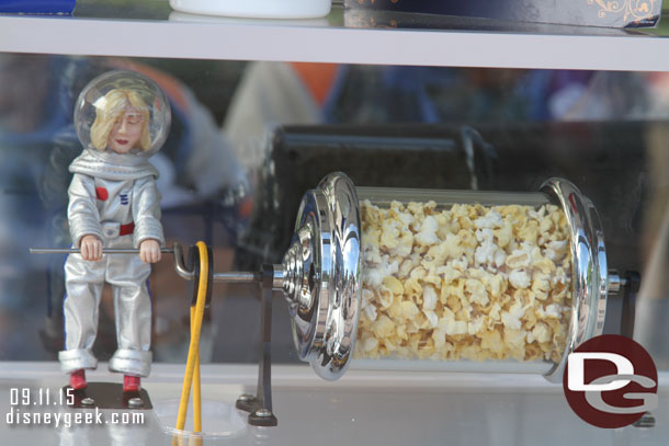 A space woman turning popcorn in Tomorrowland.
