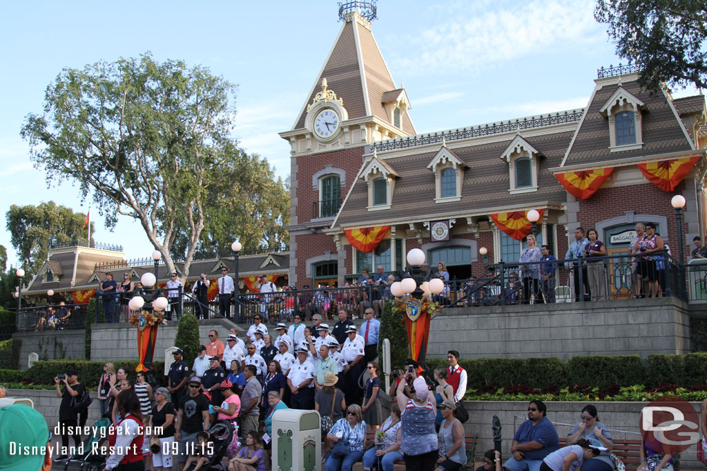 The group that marched in was positioned on the steps of the train station.