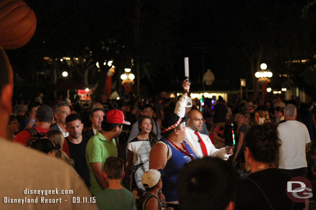 A group making their way up Main Street with a camera crew.