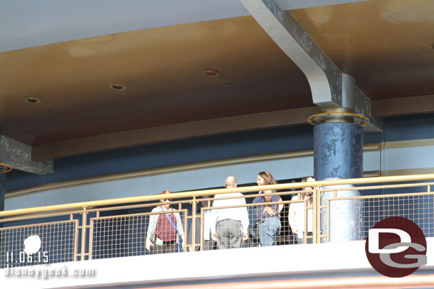 Groups of Cast Members roaming around the upper level of the Tomorrowland Exposition Center