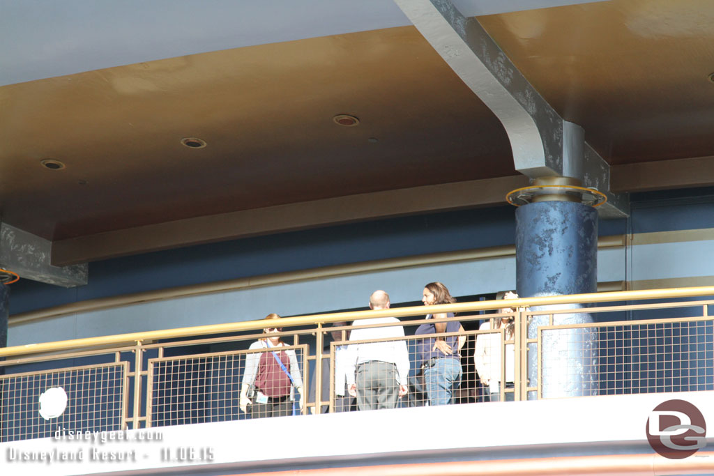 Groups of Cast Members roaming around the upper level of the Tomorrowland Exposition Center