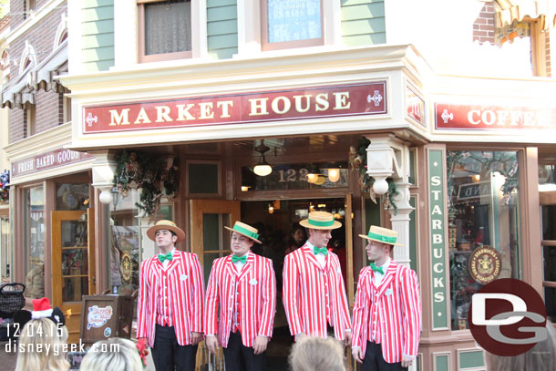 The Dapper Dans of Disneyland performing in front of the Market House