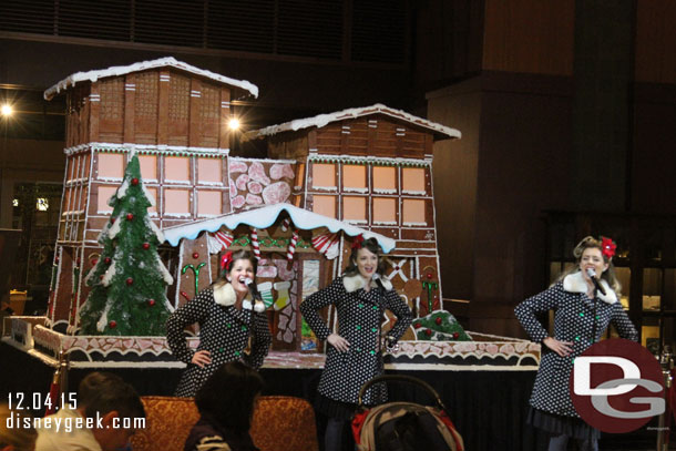 The Beverly Belles performing in front of the gingerbread house.