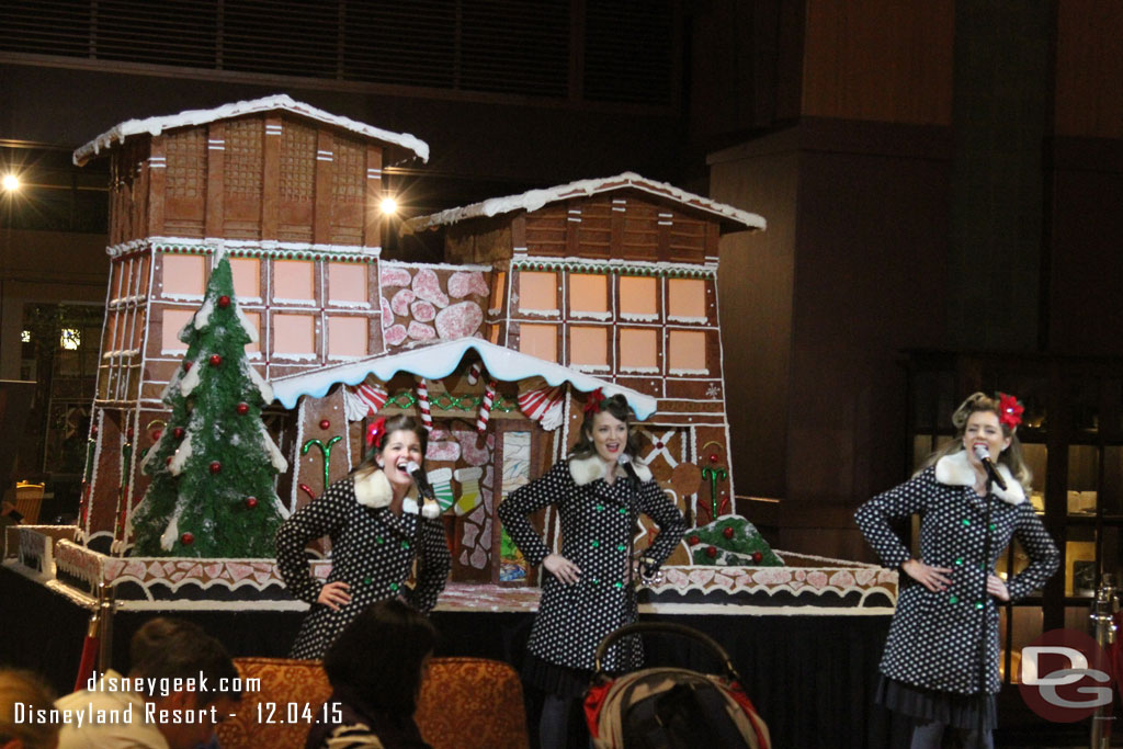 The Beverly Belles performing in front of the gingerbread house.