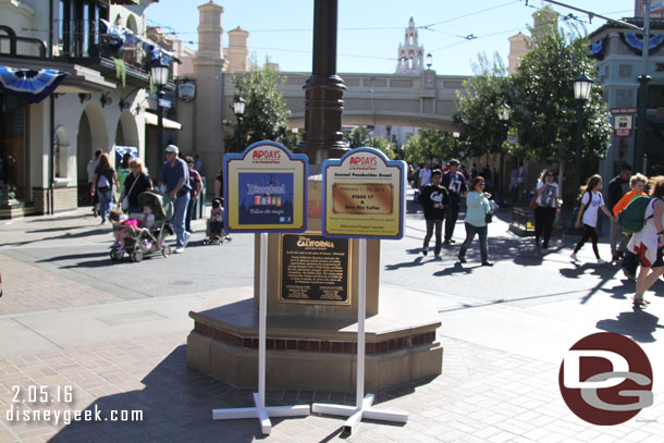 Signs advertising the AP Days near the dedication plaque.