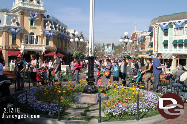 A look toward the castle.  The guests around the flag pole are in line for Mickey, he is just to my left.