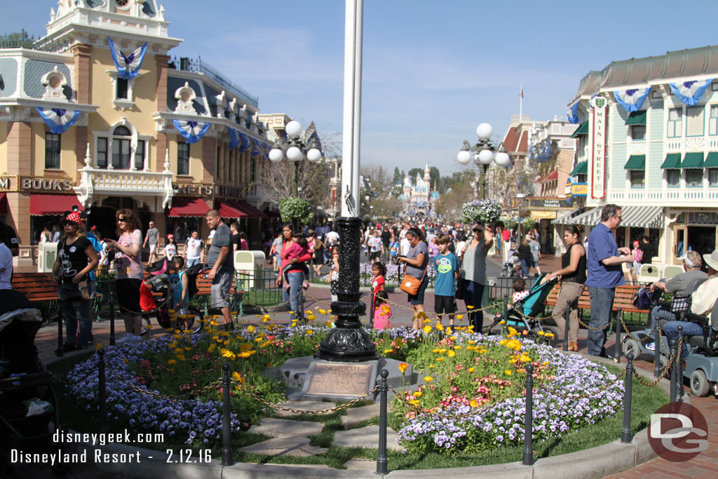 A look toward the castle.  The guests around the flag pole are in line for Mickey, he is just to my left.