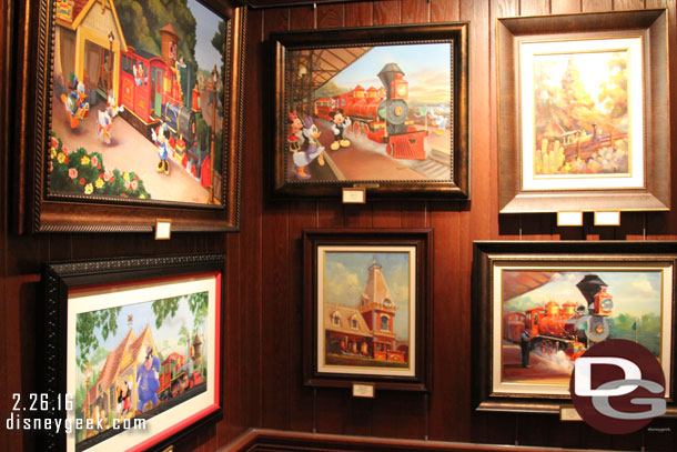 Some train related artwork in one are of the gallery.