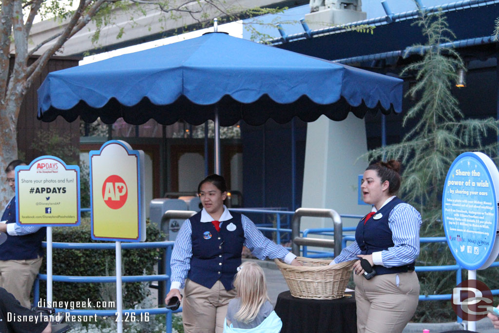 Cast Members out front passing out buttons.