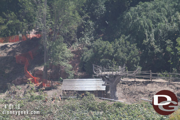 The old cabin and tree house is still along the former banks of the Rivers of America.  The land around it is being cleared.