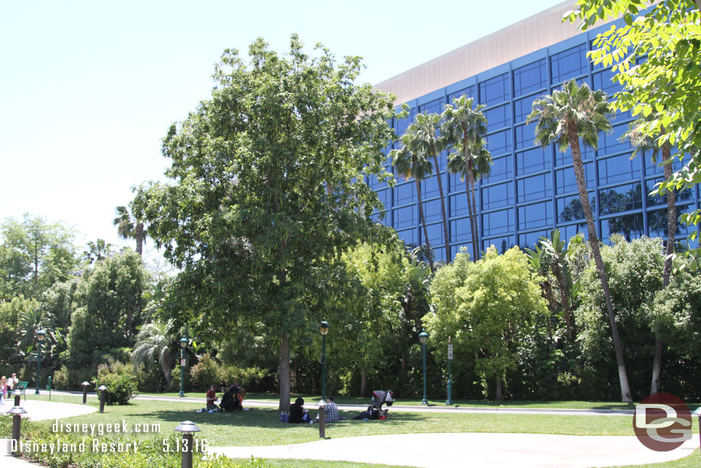 Guests enjoying the great afternoon under the trees near the Disneyland Hotel.