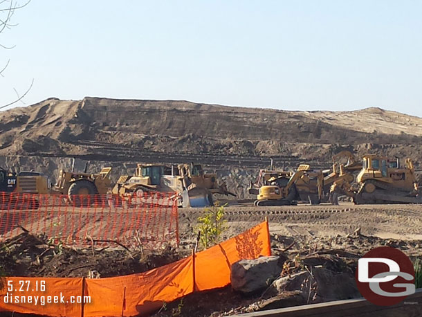 This gives a good sense of scale on the mound of dirt.  Look at the construction equipment in the foreground how the mound towers over it.