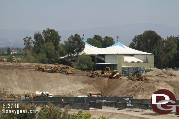 Several earth movers still adding to the mound of dirt.