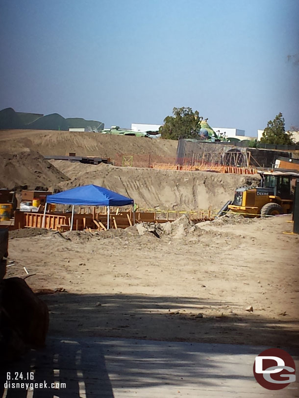 A look through the fence at the end of the Big Thunder Trail.  Looks to be conduit work in the foreground and a wall going up in the background.