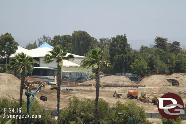 Trucks are still hauling away dirt.   In the distance the foundation for something appears to be taking shape.