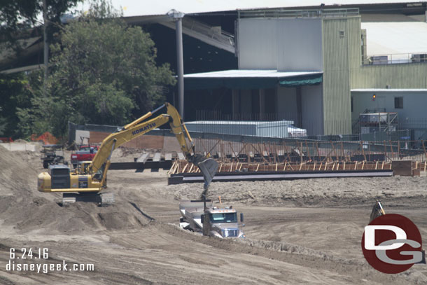 Trucks being loaded with dirt to haul away.  This is what is left of the front portion of the large mound.