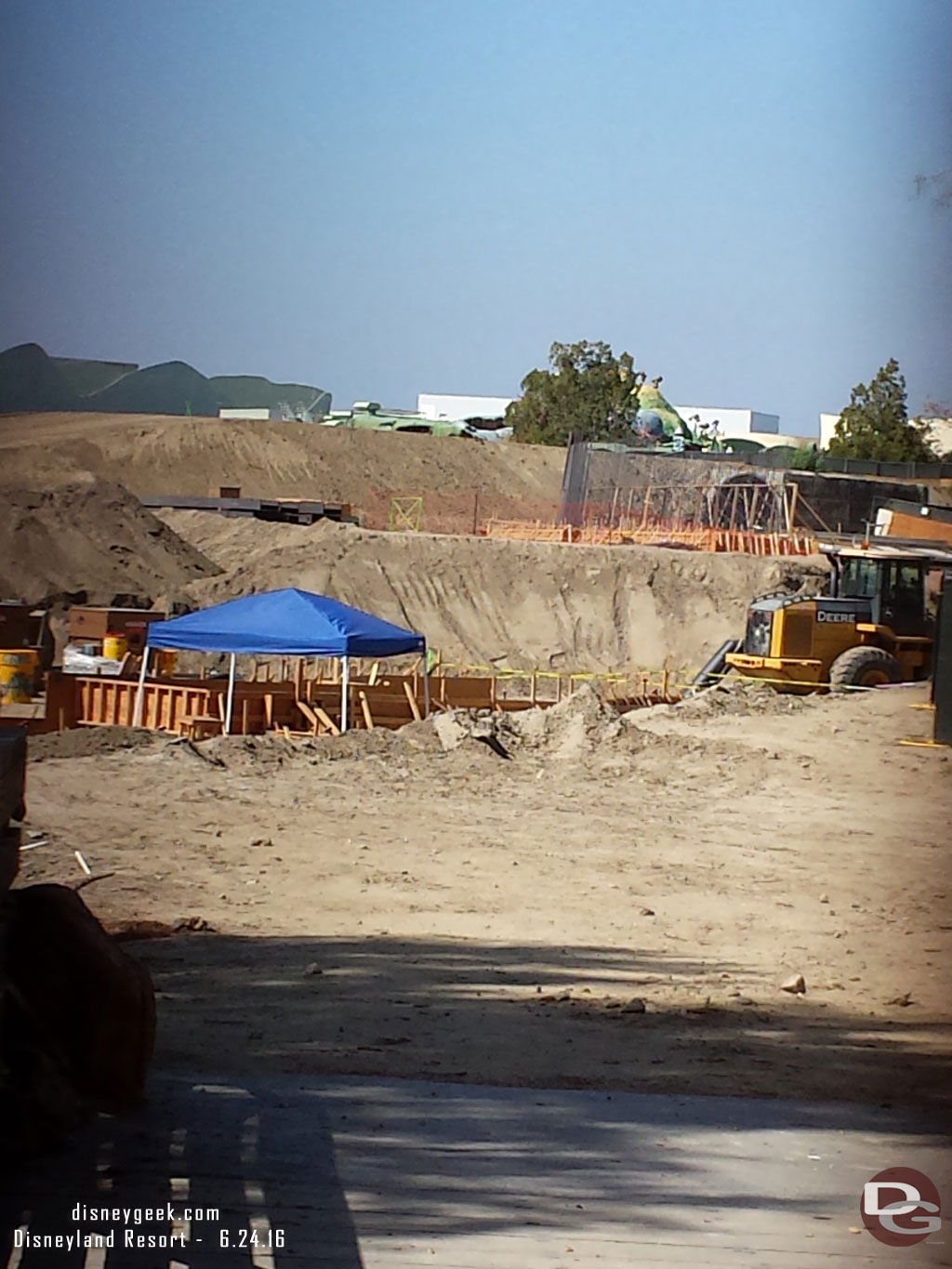 A look through the fence at the end of the Big Thunder Trail.  Looks to be conduit work in the foreground and a wall going up in the background.