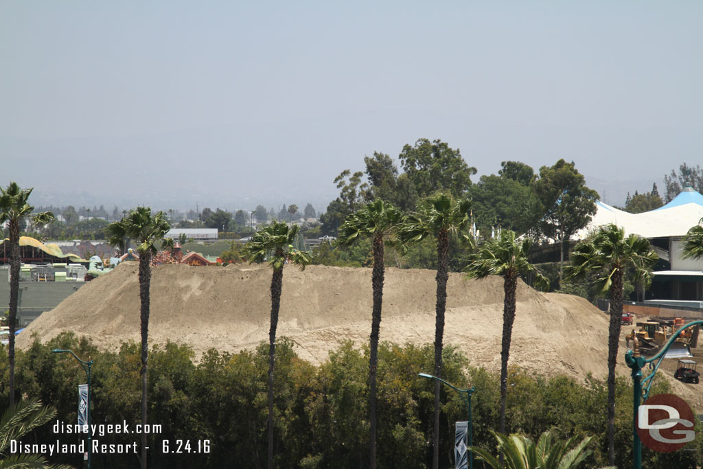 A pan from the left to the right.  The large mound of dirt has shrunk but is still substantial.