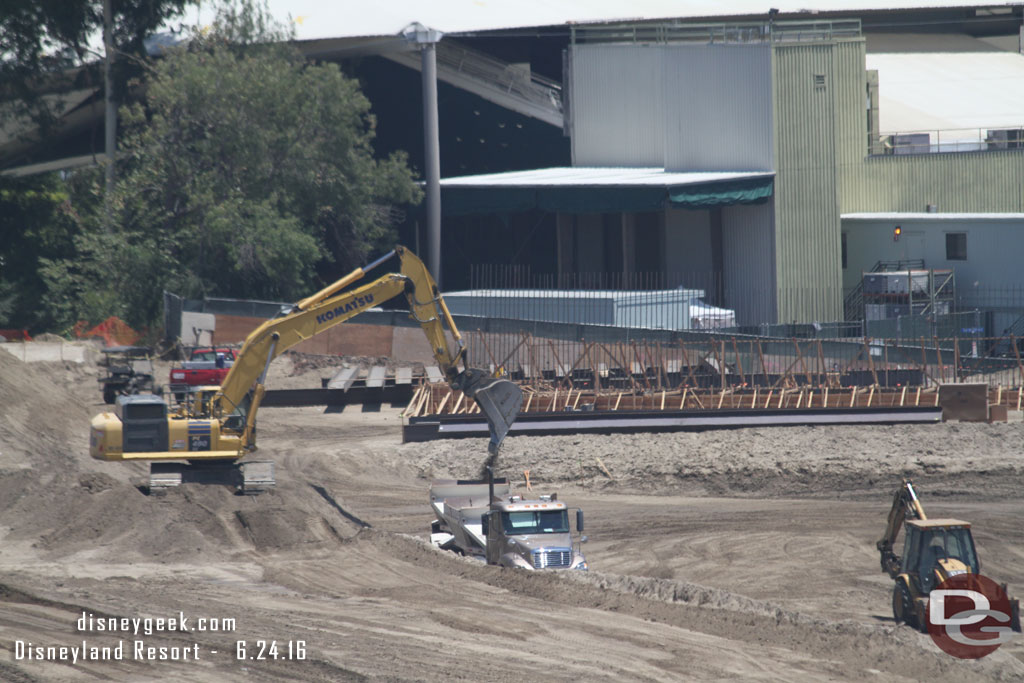 Trucks being loaded with dirt to haul away.  This is what is left of the front portion of the large mound.