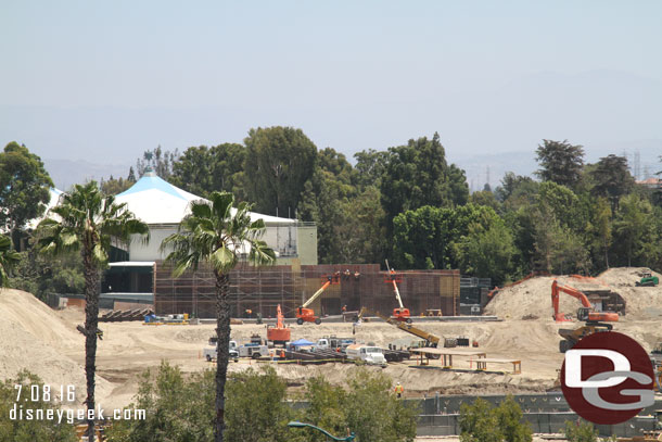 A wall is taking shape on the far side of the site, near Fantasyland.