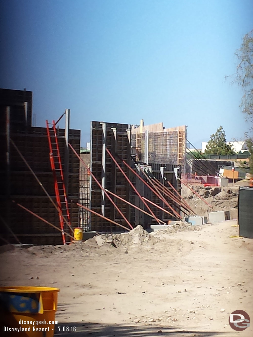 A look through the fence.  You can see the walls going up right along the walkway.  Assuming these will be rockwork along the Big Thunder trail.