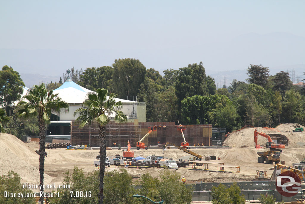 A wall is taking shape on the far side of the site, near Fantasyland.