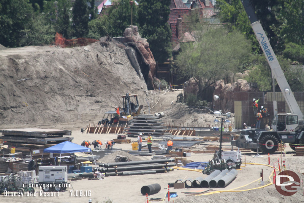 More pipes and conduit waiting to be installed.  In the background more footers being set up to extend the wall.  Guessing it will work its way to connect to the wall by the gate to Fantasyland.