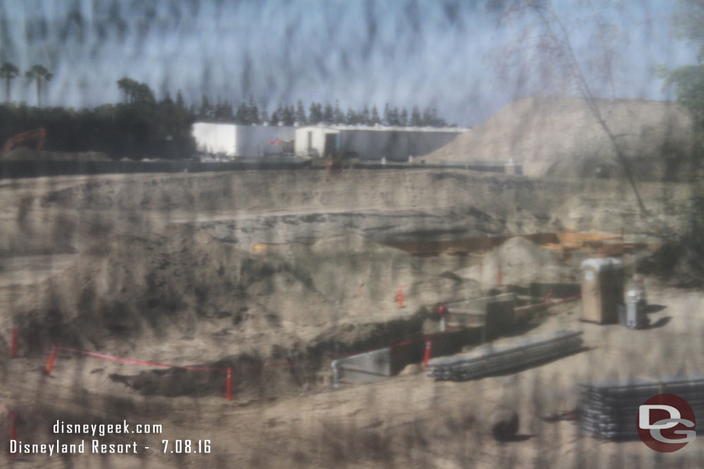 Through the fence you can see where they are laying pipes and conduit.  In the middle of the shot appears to be forms for a footer going in.