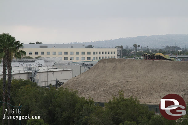 Panning across the site from left to right.  The large mound of dirt has shrunk but is still big.