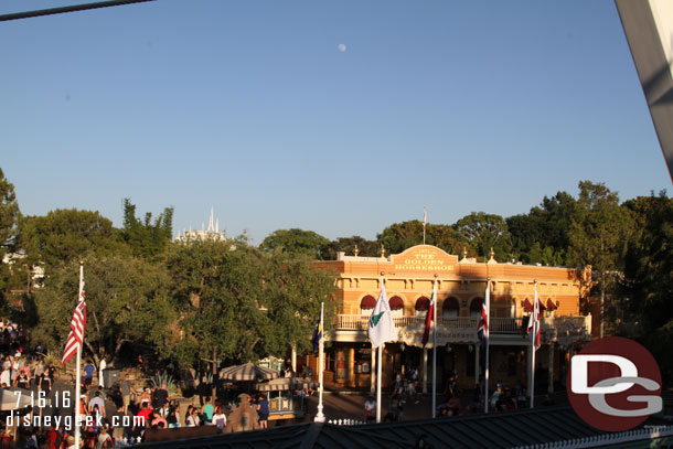 The moon was visible as the sun was setting over the park.