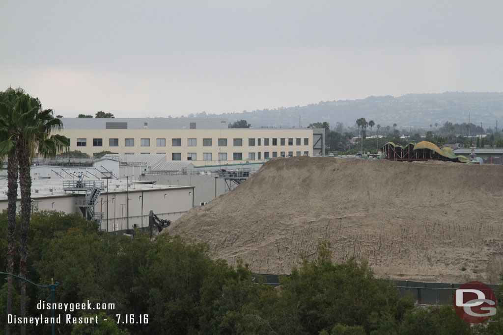 Panning across the site from left to right.  The large mound of dirt has shrunk but is still big.