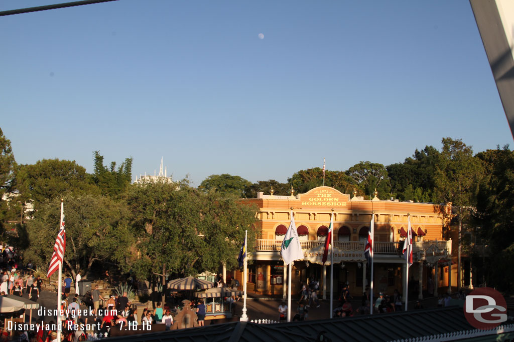 The moon was visible as the sun was setting over the park.