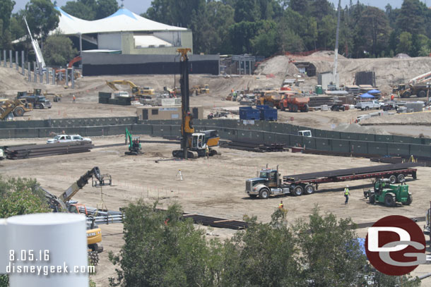 Is this possible the start of work on the foundation for one of the show buildings?  It appeared they were driving steel beams into the ground, maybe to be used as retaining walls to dig a basement.  Just guessing at this point.