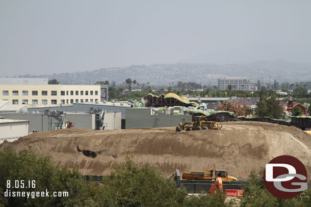 The mound of dirt is slowly disappearing.  As dirt is used they continue to level/sculpt it.